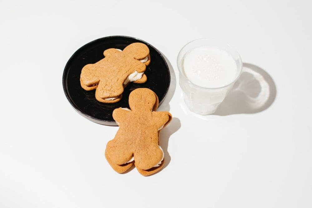 Ounce of Hope's 50mg delta-9 gingerbread creme pies, one on a plate, next to a glass of milk